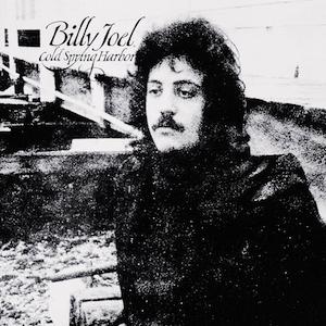 A black and white image of the cover of Billy Joel's Cold Spring Harbor album, with Joel standing in front of a dock in the community.