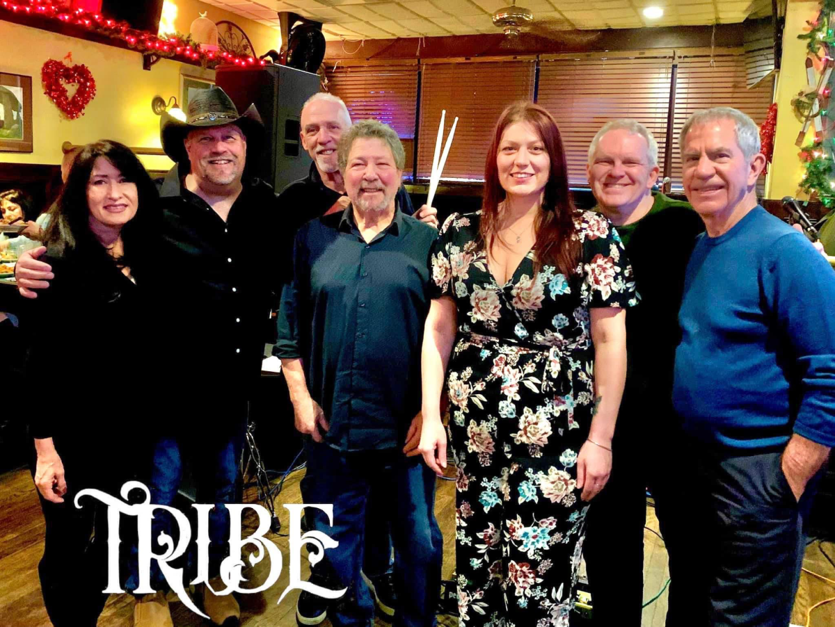 A color photo of the seven members of the Tribe Band.