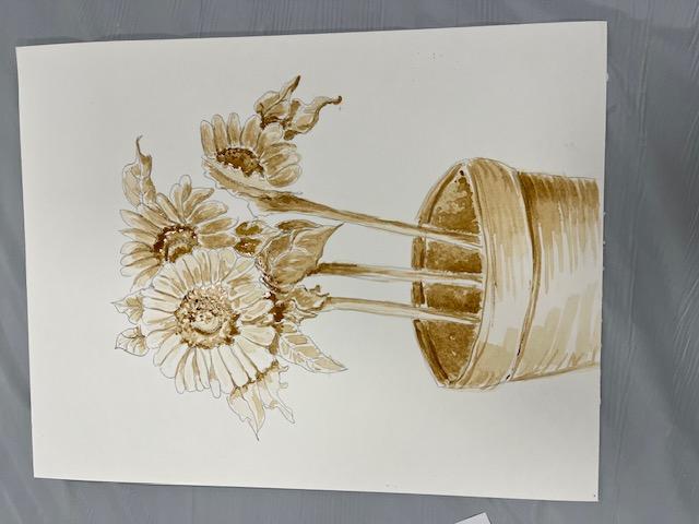 An image of sunflowers growing in a pot painted with coffee.