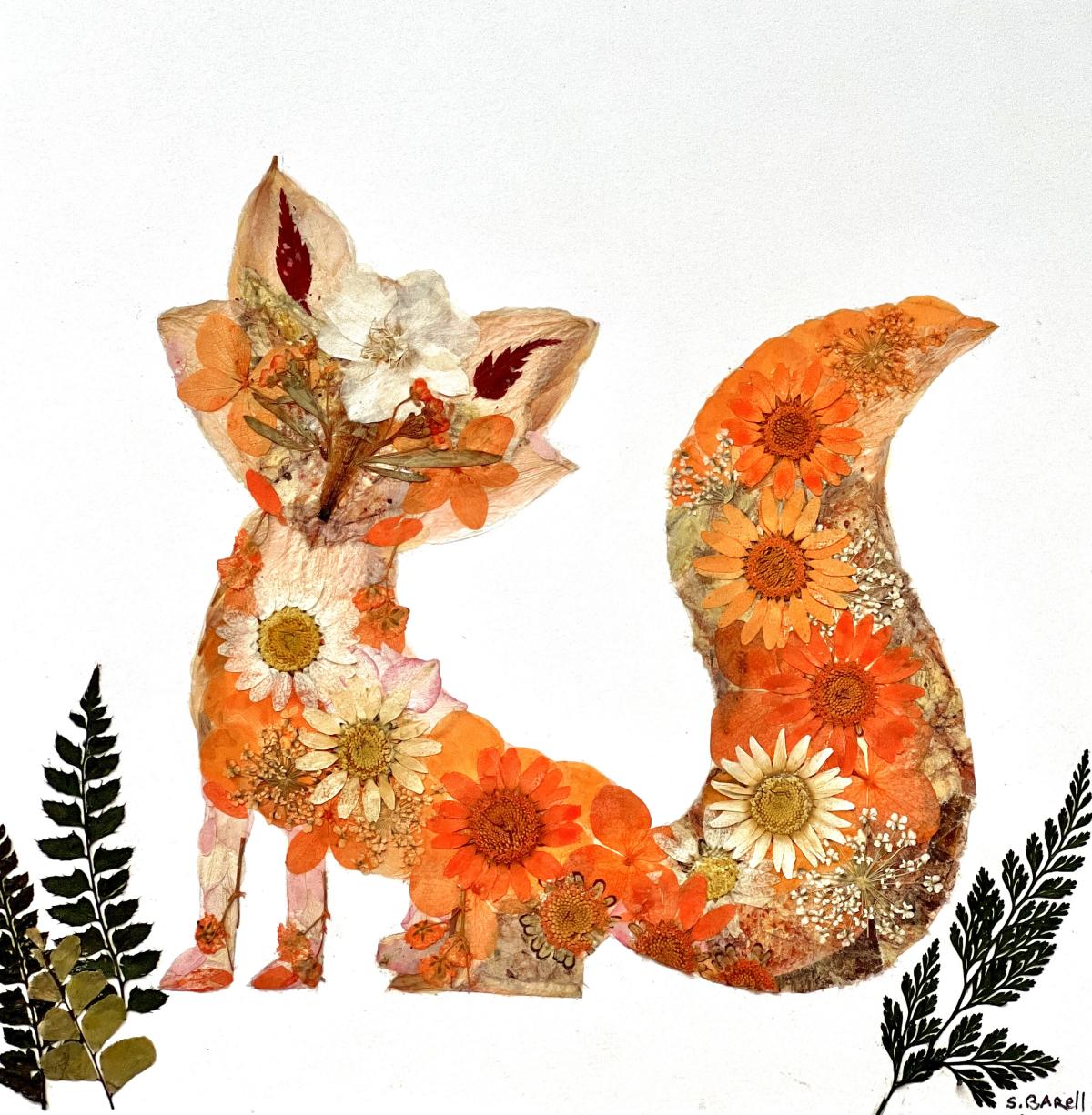 An image of a fox made from pressed flowers in shades of orange and red.