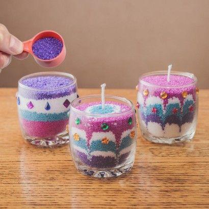 A photo of three jar candles made with wax granules.