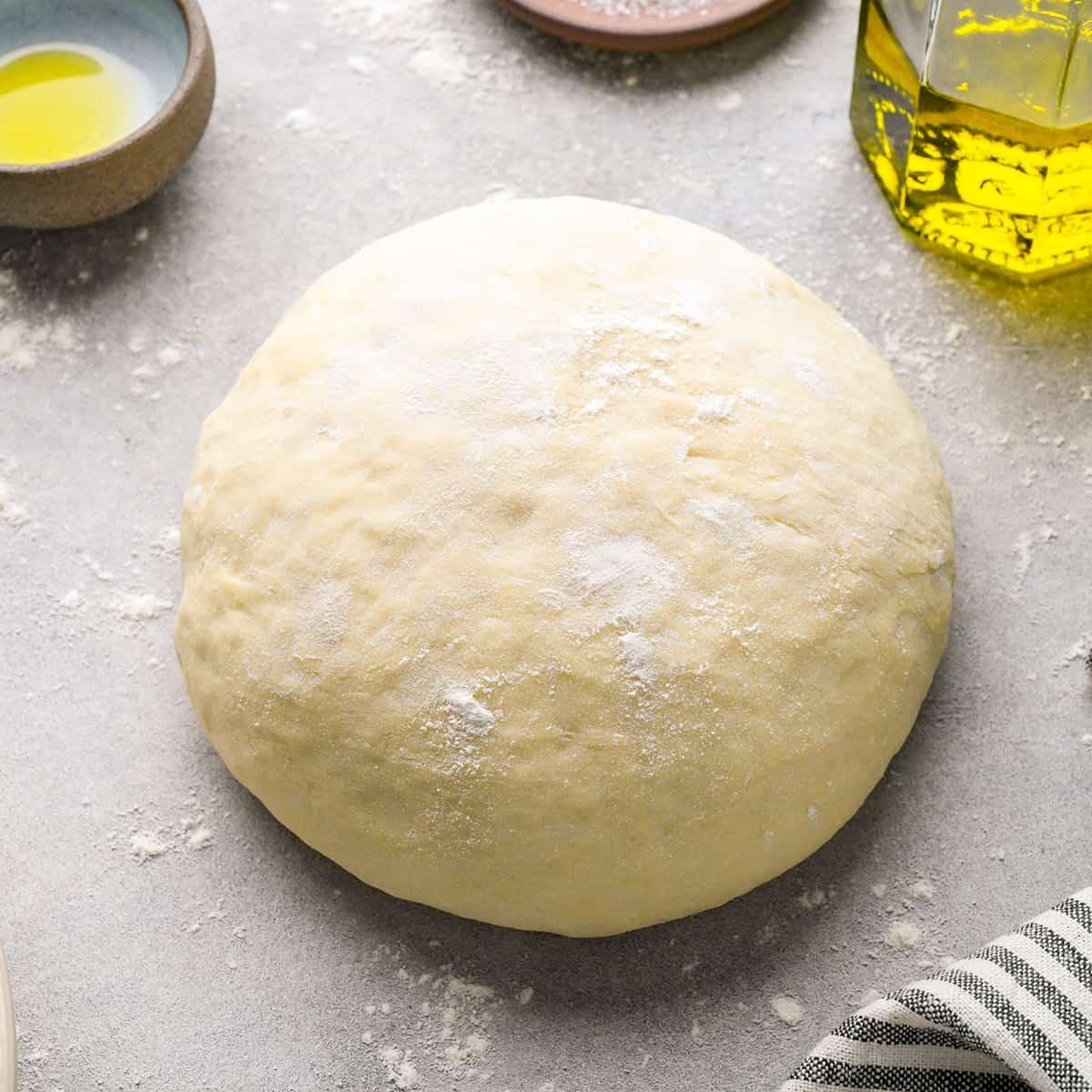 A photo of a round of pizza dough.