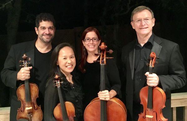Members of the Poetica string quartet holding their instruments.