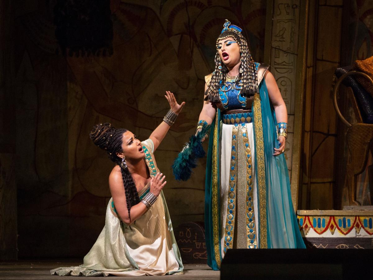 A color photo of two women performing in the opera Aida.