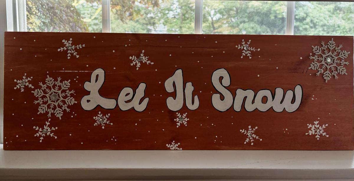 A color photo of a Let It Snow sign.