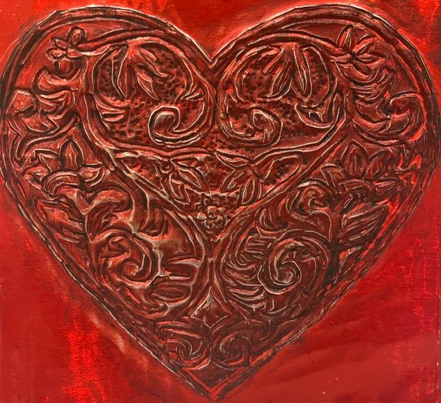 A color photo of a metal embossed heart.